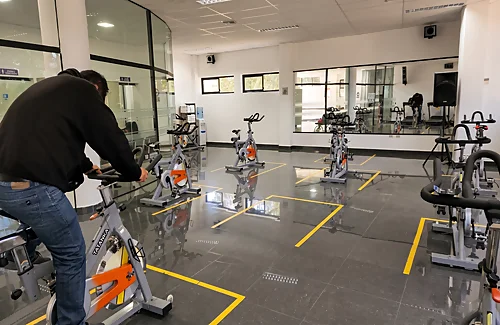 Sala de gimnasio universitario con bicicletas estáticas